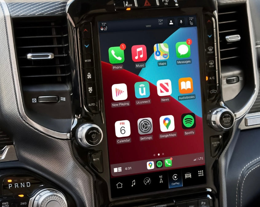 A 12-inch ram touchscreen infotainment system installed in a vehicle's dashboard, showcasing a user interface with various app icons, indicating support for Wireless Apple CarPlay and Android Auto.