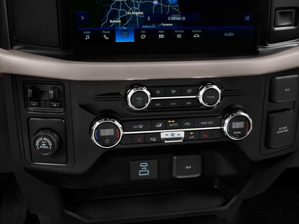 Stock Ford dashboard showing navigation display and climate control knobs